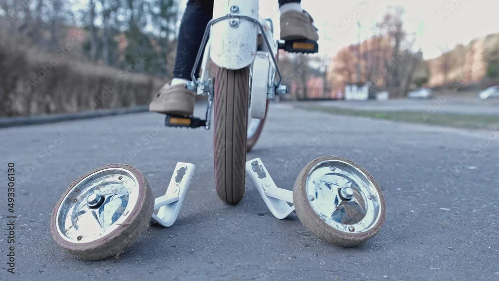 Young Child Learning To Ride a Bike without Support Stabilizer Wheels Left Behind